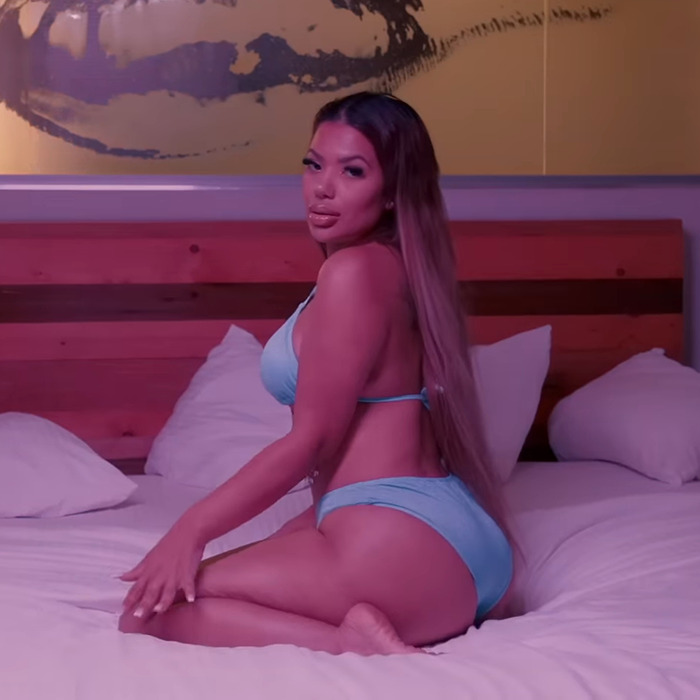 NYPD officer Melissa Mercado in blue swimwear poses on bed.