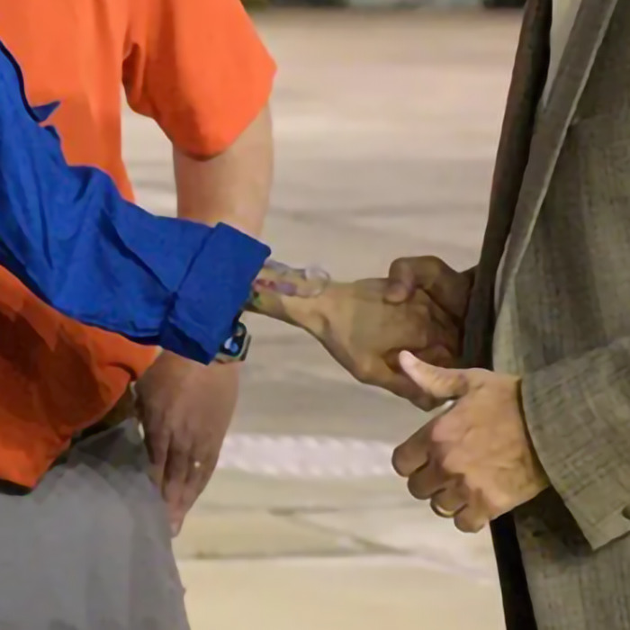 Astronaut's hand appearing frail during handshake, raising health concerns from doctors in new image.