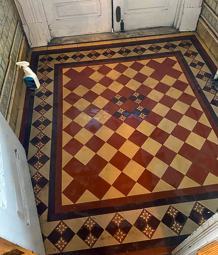 Vintage checkered tile floor in an entryway as part of a home discovery.