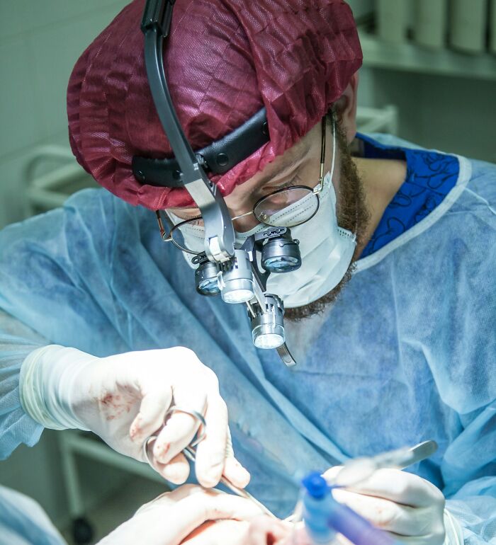Doctor performing surgery to remove unusual objects from a patient's body.