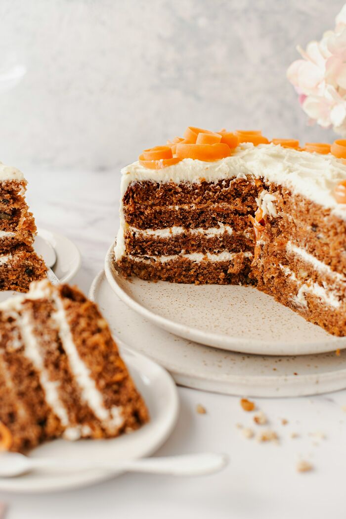 Carrot cake on a plate with slices, possibly a wedding dessert red flag.