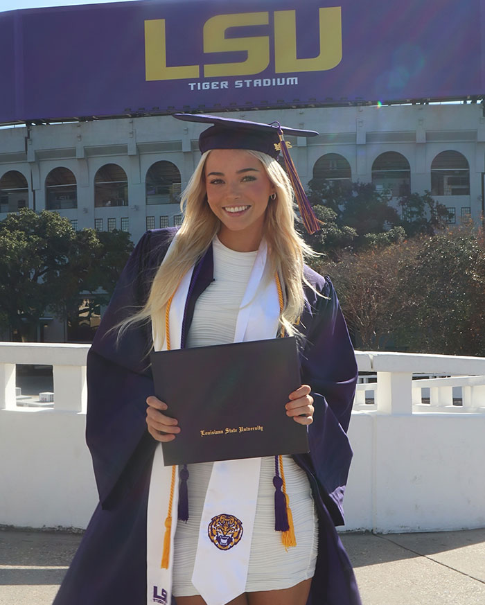 Graduation ceremony at LSU, highlighting diverse sources of net worth beyond gymnastics.