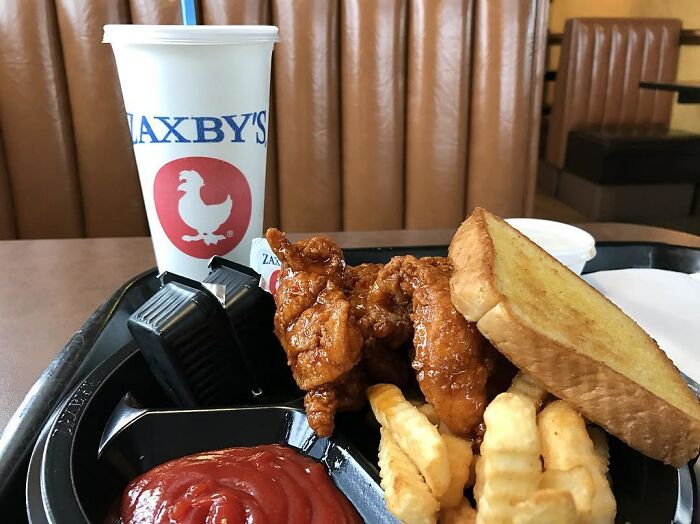 Zaxby's meal with chicken tenders, crinkle fries, toast, and a drink, showcasing a hyped fast food option.