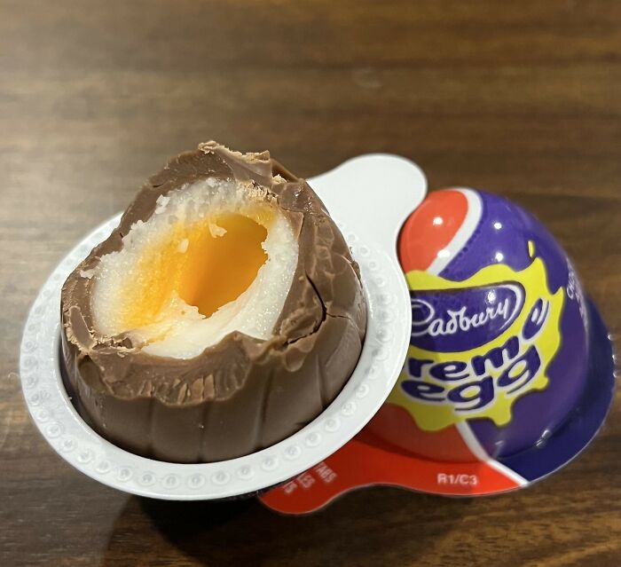 Cadbury Creme Egg with a chocolate shell and creamy filling, a divisive treat among food enthusiasts.