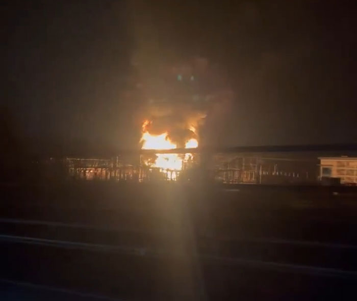 Fire and smoke at night after explosion near Heathrow Airport, affecting flights.