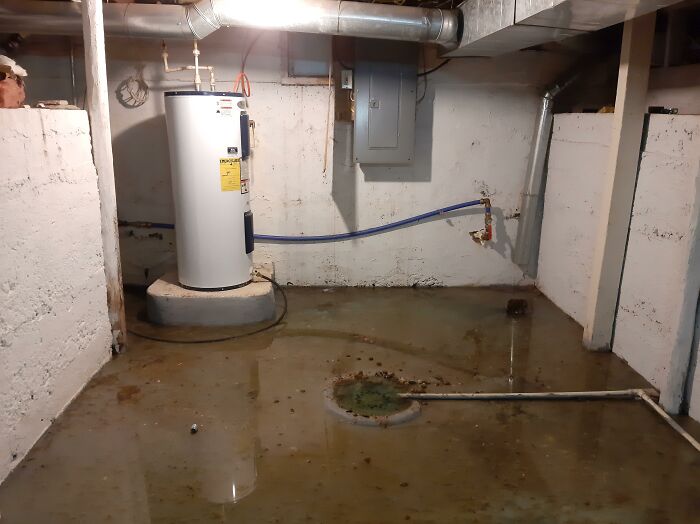 Flooded basement with a water heater, a common challenge for first-time home buyers.