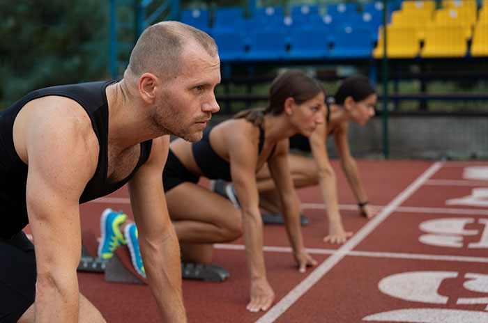 Athletes in starting position on a track, ready to race, exemplifying the values older generations embrace.