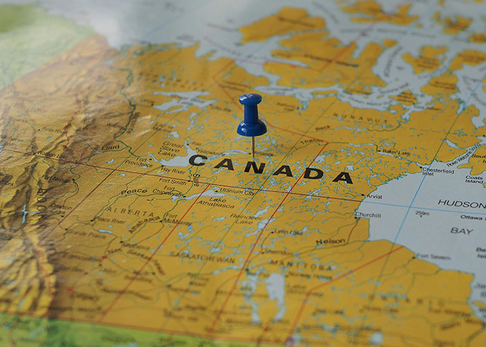 Map with a blue pin marking Canada, highlighting a country.