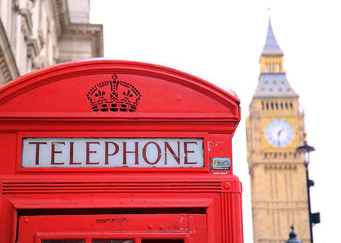 Red telephone booth with Big Ben in the background, symbolizing British culture.