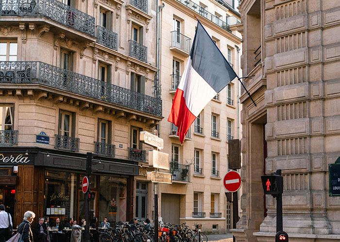 French flag on a Parisian street, highlighting a country often made fun of.