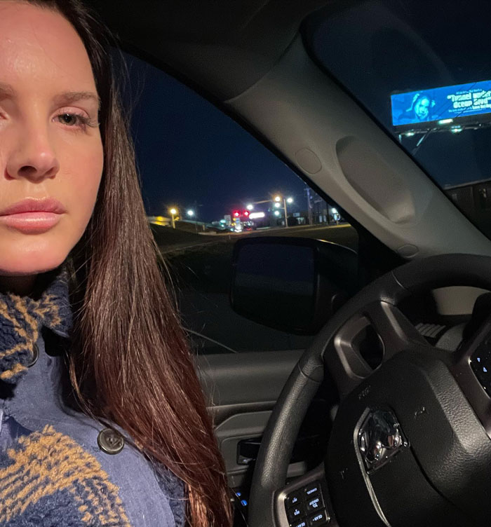 Celebrity in a car at night, showcasing a moment of pettiness.