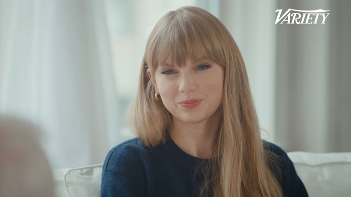 Celebrity smiling during a Variety interview, wearing a navy sweater.