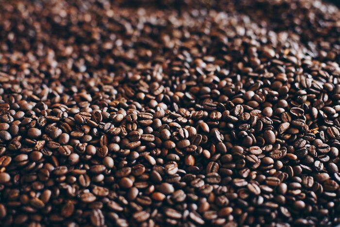 A pile of roasted coffee beans, illustrating a simple approach to enhance life.