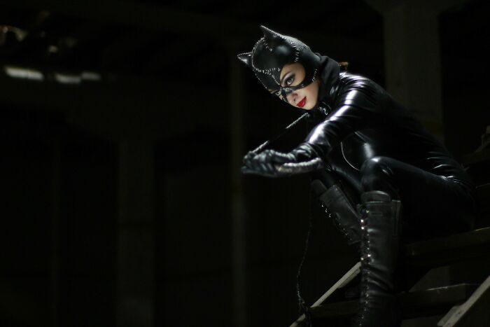 Person dressed as a cat in a black costume, showcasing an unprofessional look for work.