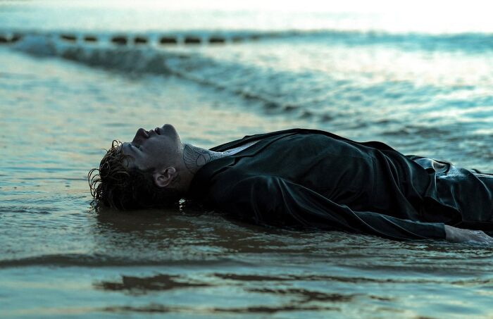 Man in the ocean, lying back on the water, representing sudden dizziness awareness.