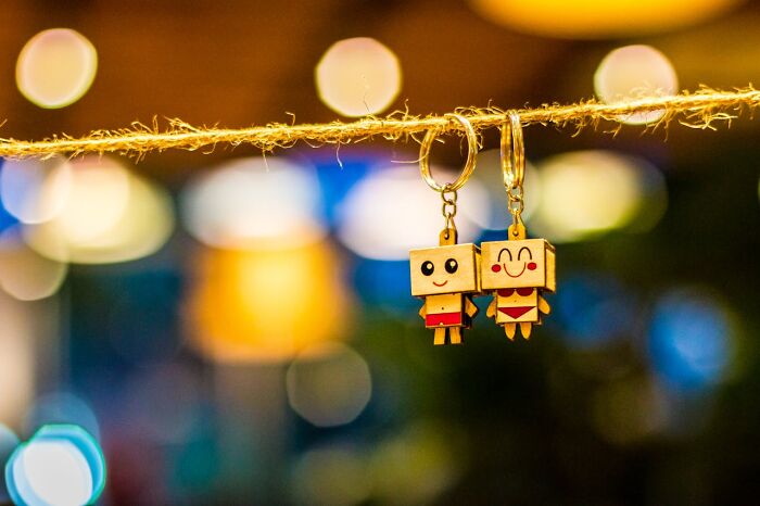 Cute keychain figurines hanging on twine, representing a worst bonus example at work.