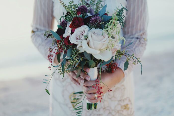 Bride holding a bouquet, symbolizing unforgettable wedding nightmares with beautiful flowers in her hands.