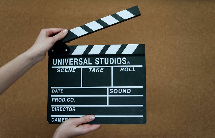 Clapperboard held by hands, used in movie production. Clapperboard held by hands, used in movie production.