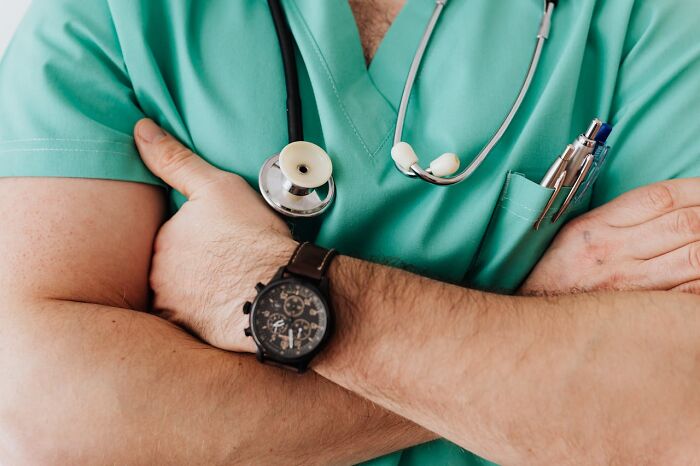 A person in green scrubs with a stethoscope, representing friendship challenges among professionals.
