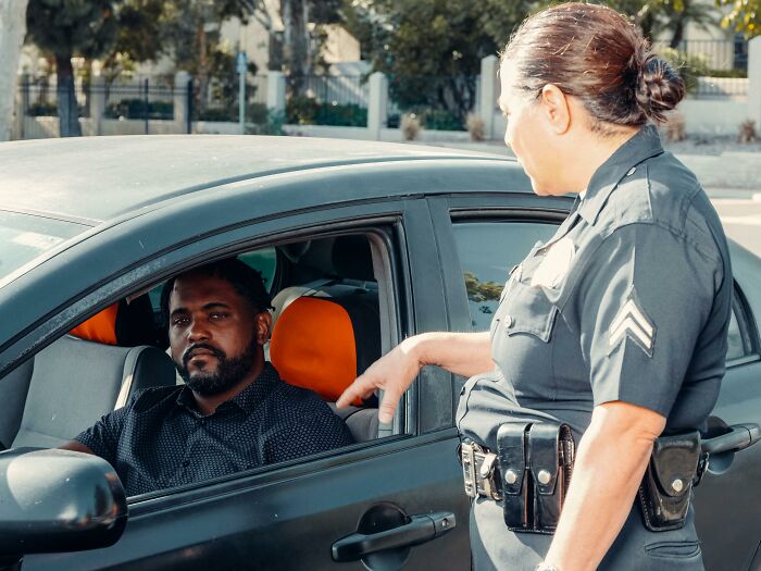 Police officer interacting with a driver during a traffic stop.