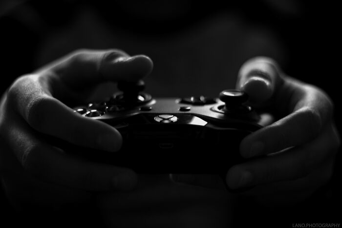 Hands gripping a gaming controller, ready for an engaging session similar to reading cool Wikipedia articles.