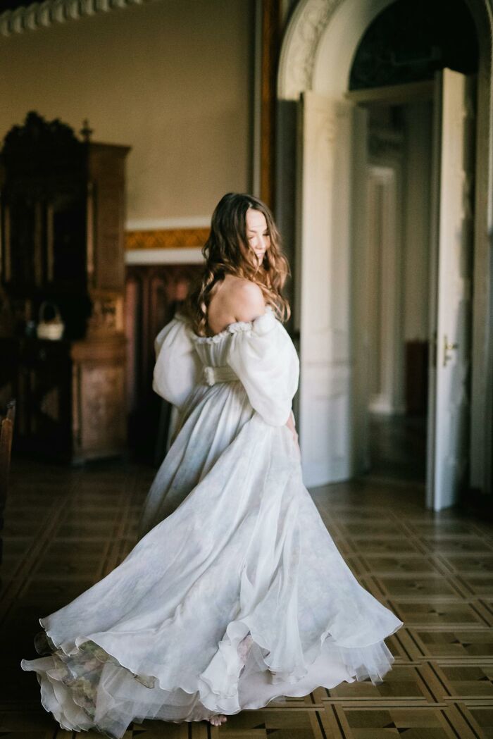 Bride in an elegant wedding dress twirling in a vintage room, highlighting red flag moments wedding theme.
