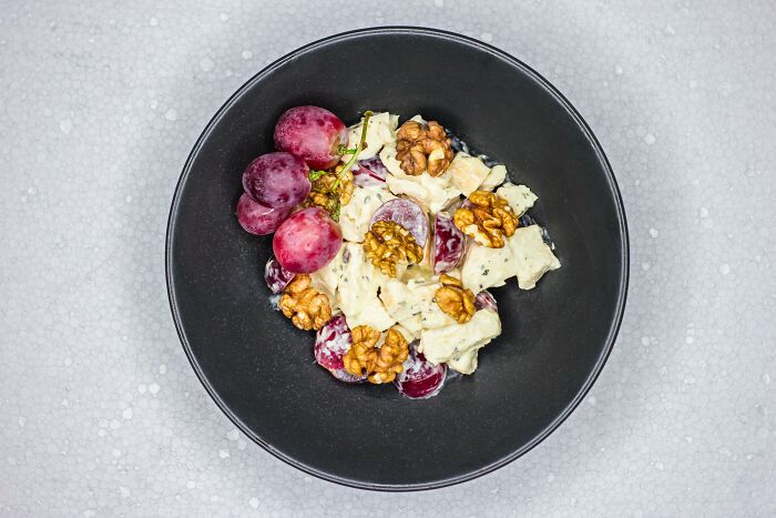 Elegant dish with grapes, walnuts, and cheese, symbolizing an unforgettable wedding meal for the wrong reasons.
