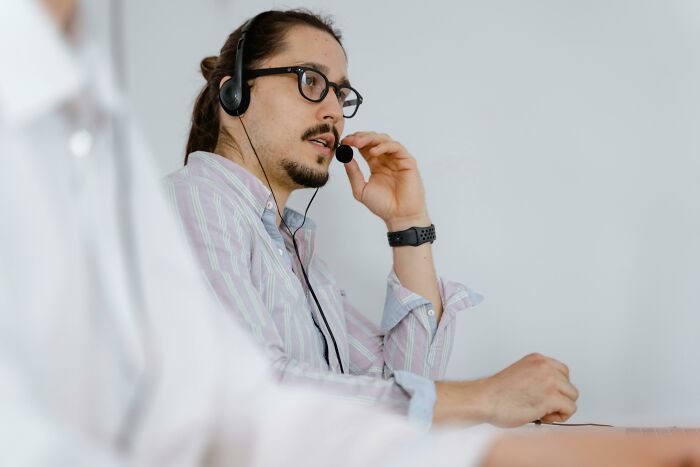A person wearing glasses and a headset, engaging in discussion about common stereotypes online.