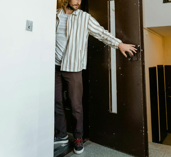 Man exiting a building, symbolizing being fired on the spot in a workplace scenario.