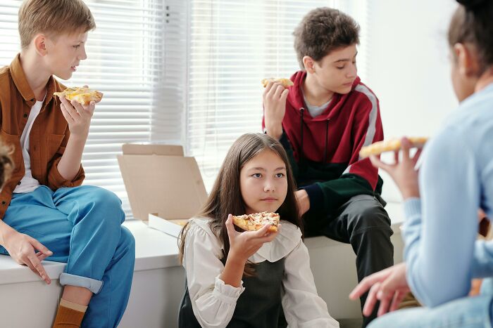 Kids enjoying pizza together in a relaxed setting, illustrating simple approaches to better life moments.