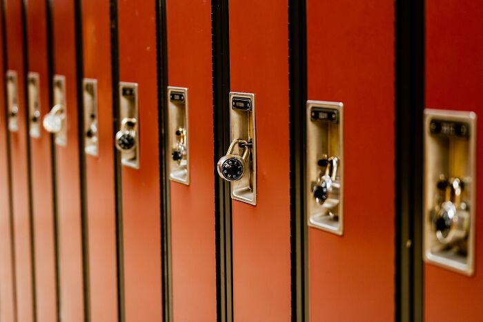 Red school lockers with combination locks lined up.