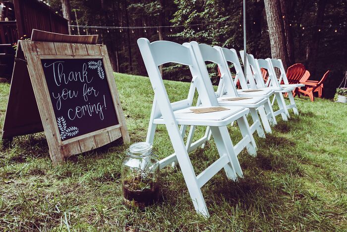 Empty wedding chairs and a thank you sign, capturing an unforgettable wedding nightmare.