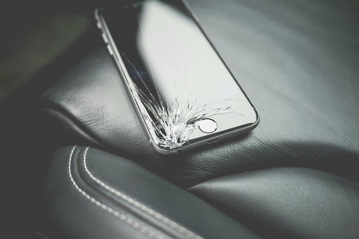 C*****d phone on a leather seat, suggesting unsettling story elements.