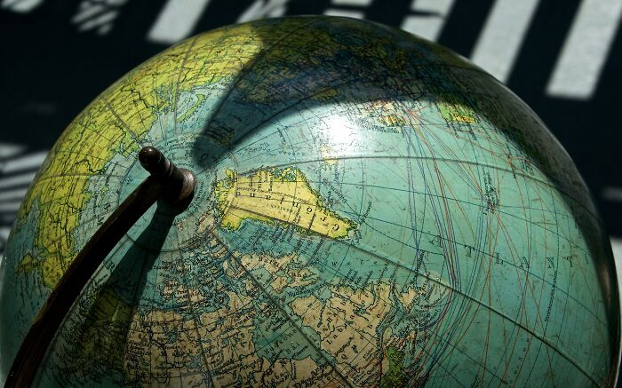 Close-up of a globe with shadows on North America, emphasizing geography and illumination.