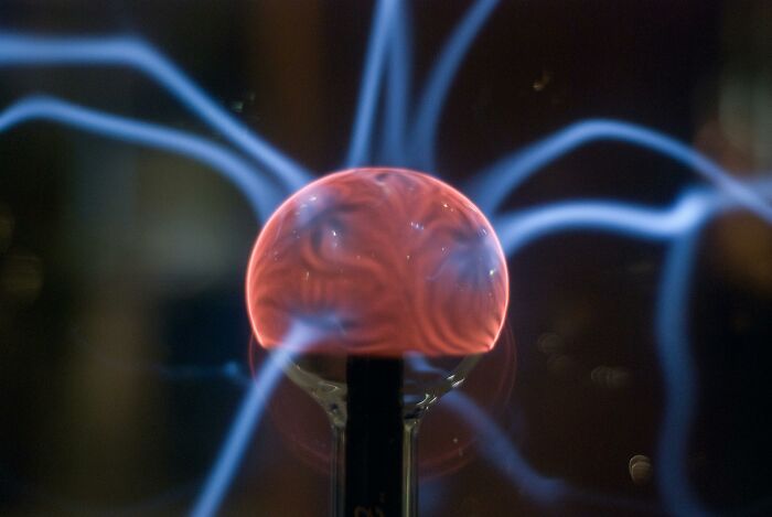 Plasma globe emitting blue and pink lightning, showcasing science general knowledge.