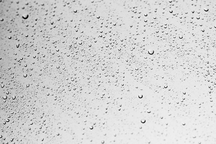 Raindrops on glass, a close-up capturing the beauty of droplets, often getting more hate than deserved.