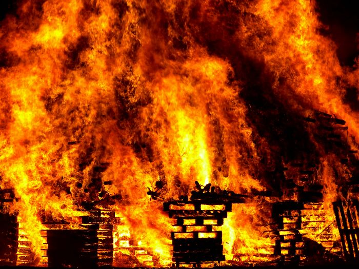 Burning wooden pallets in a large fire, representing a wedding nightmare scenario.