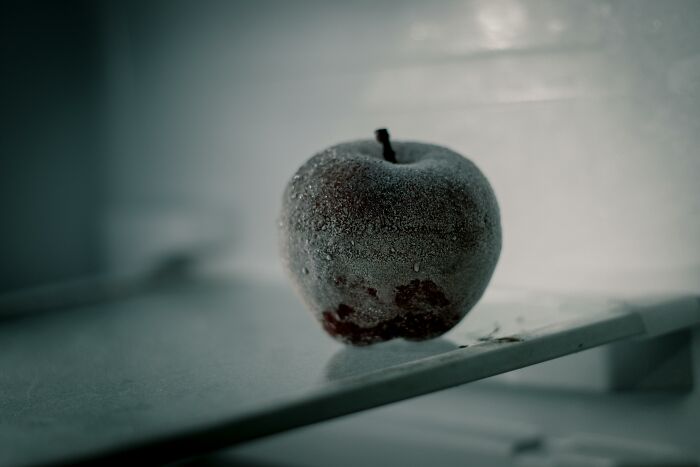 A frosty apple sitting on a shelf, illustrating simple approaches to a better life.