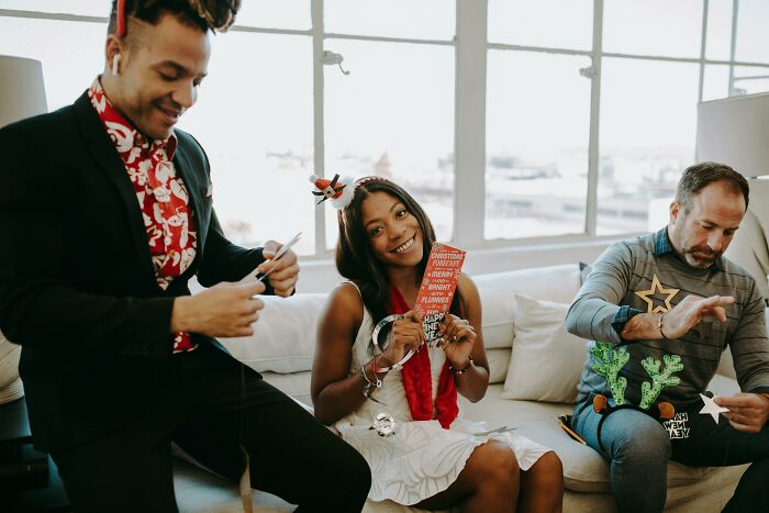 People at a festive gathering, holding decorations, and smiling, reminiscent of being picked last in gym class experiences.
