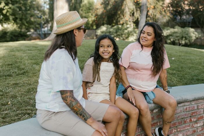 Family enjoying a simple moment together on a park bench, highlighting better life through connection.