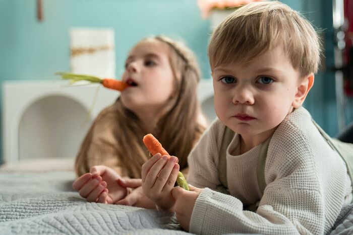 Children on a bed with carrots, representing historical facts taught in school that are now proven wrong.