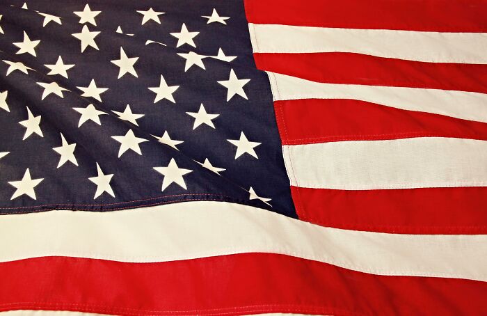 Close-up of an American flag showcasing stars and stripes, symbolizing patriotism and national pride.