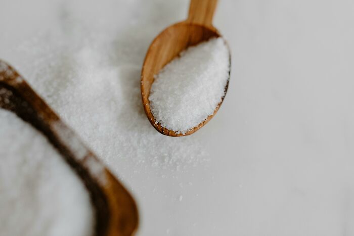 Wooden spoon with salt, illustrating simple approaches for better living.