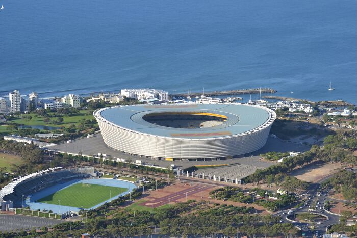 Aerial view of a large soccer stadium by the sea, one of the famous cathedrals of soccer where legends are born.
