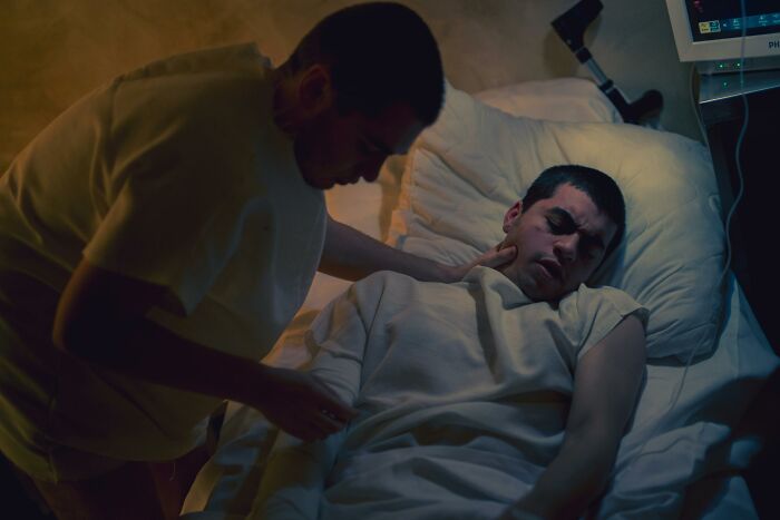 Hospital worker tending to a patient, highlighting patients' regrets.
