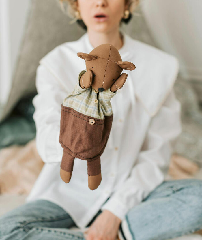 Person holding a handmade puppet, symbolizing worst bonus experiences shared by many people.
