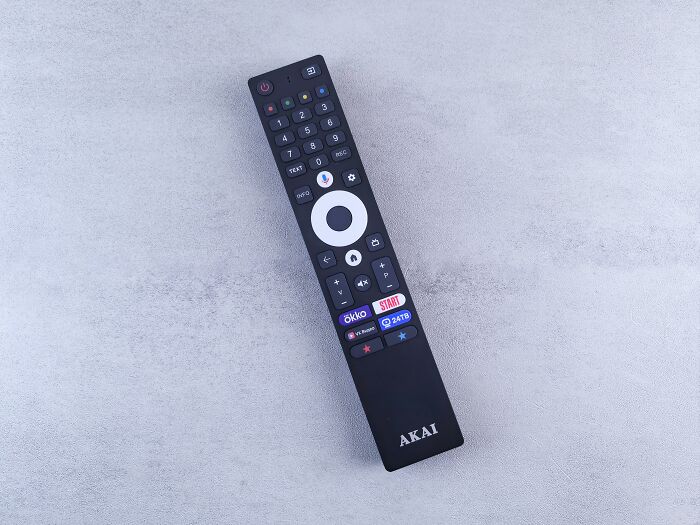 Remote control on a gray surface; a common device folks can't believe hasn't been advanced already.