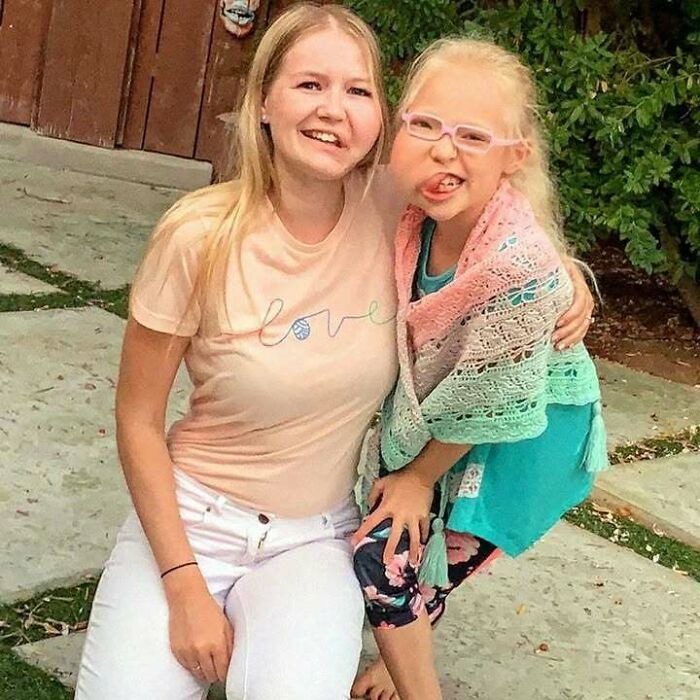 Smiling woman and child in an outdoor setting, exuding positivity and upliftment with their joyful expressions.