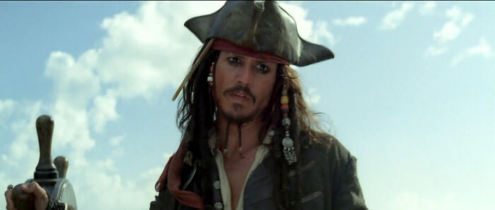 Pirate captain with tricorn hat, embodying an iconic role perfect for the actor against a blue sky backdrop.