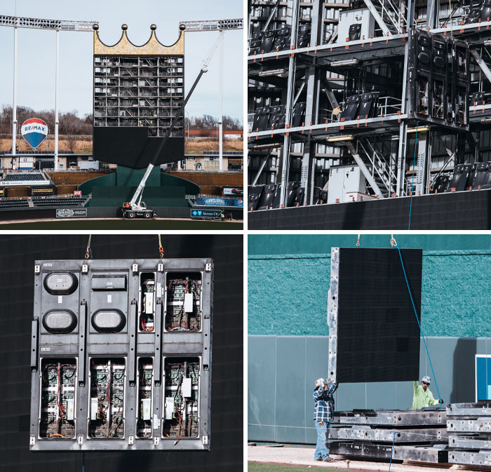 LED display installation at an iconic stadium, workers setting up structural components for the scoreboard.